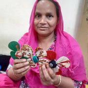 Woman Artisan holding a Recycled Cotton Sari Fabric Flower Garland