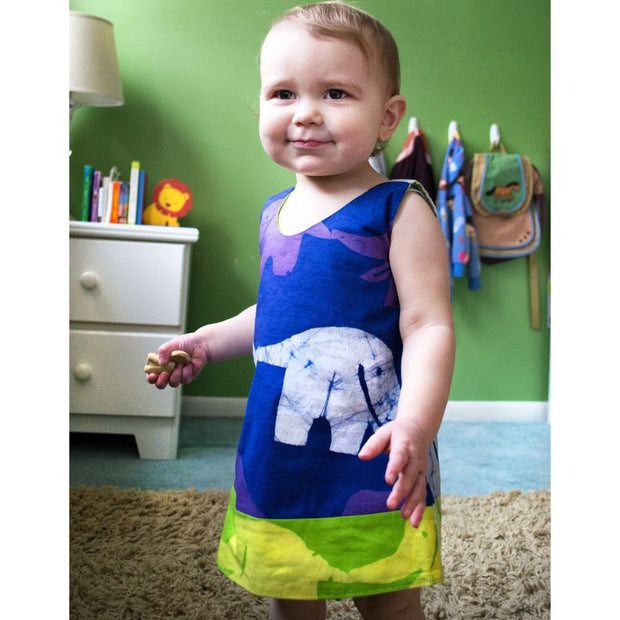Global Mamas Girls Reversible Dress - Elephants in Blue and Lime Green on model