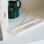 Indukala Moon Phases White Marble Double Incense Holder lifestyle with two incense sticks