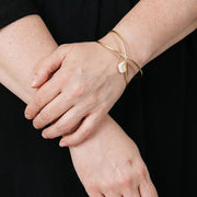 Gwyneth Charm Brass Bracelet on model