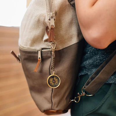 Compass Key Chain hanging from backpack