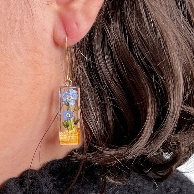 Resin Bar Earrings with Palo Santo and Forget-me-not Flowers on model