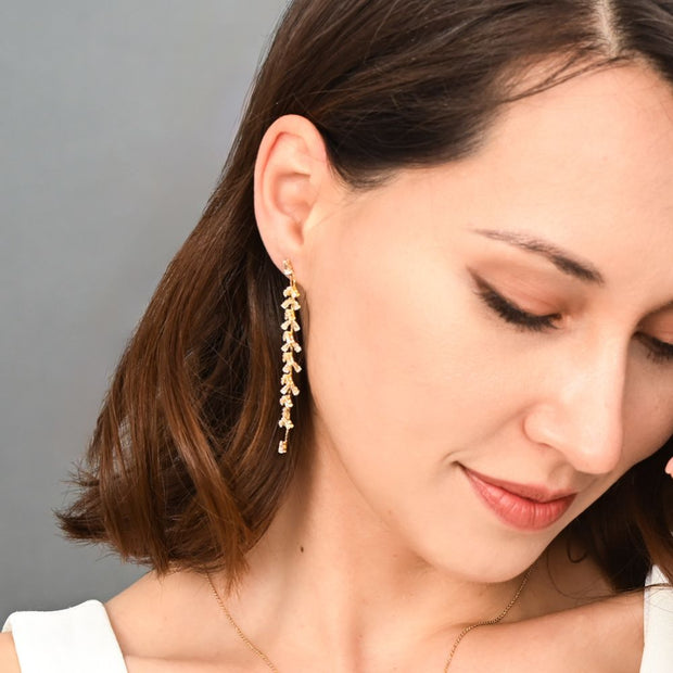 Graceful Willow Zircon and Gold Dangle Post Earrings on model