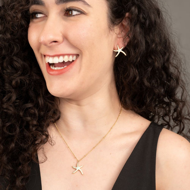 Starfish Hope Stud Earrings in Gold on model who is also wearing the matching Starfish Hope Necklace