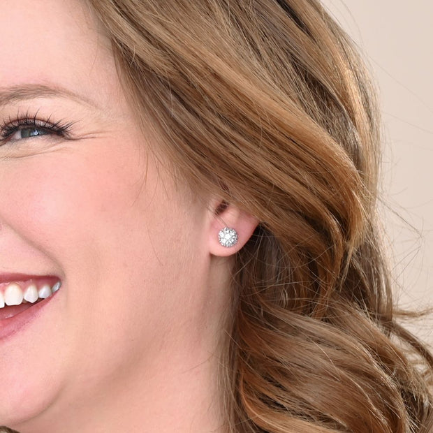 Close-up of a woman wearing Lustre Bloom Studs in Platinum