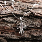 Silver Modern Cross Pendant Necklace styled on tree bark