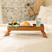 Mango Wood Bed Serving Tray with Folding Legs with breakfast items on a bed