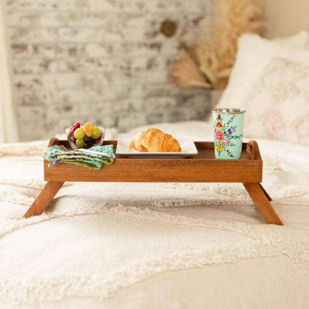 Mango Wood Bed Serving Tray with Folding Legs with breakfast items on a bed