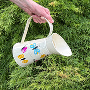 Cream Color Watering Can with Hand-painted Butterflies lifestyle