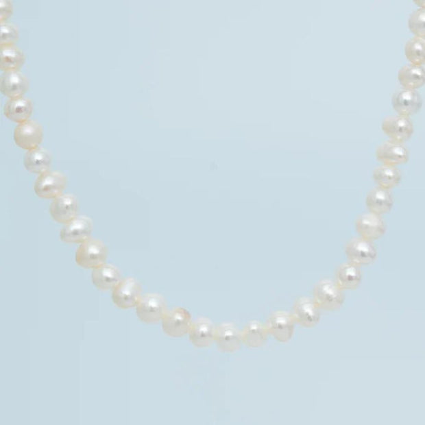 Cultured Freshwater Pearl Necklace styled with contrasting color background