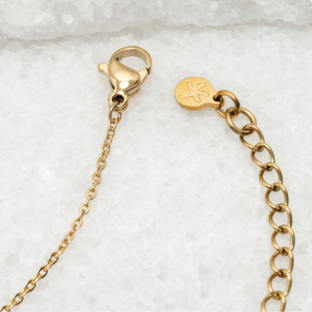 Gold chain bracelet with clasp and branded Starfish project tag detail