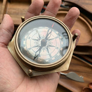 Brass Compass and Calendar Device held by hand