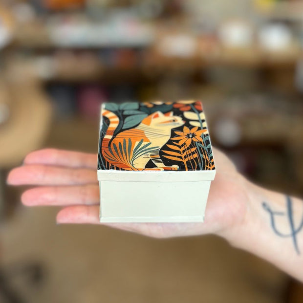 Hand holding a Small Painted Cat Tin Jewelry Box 