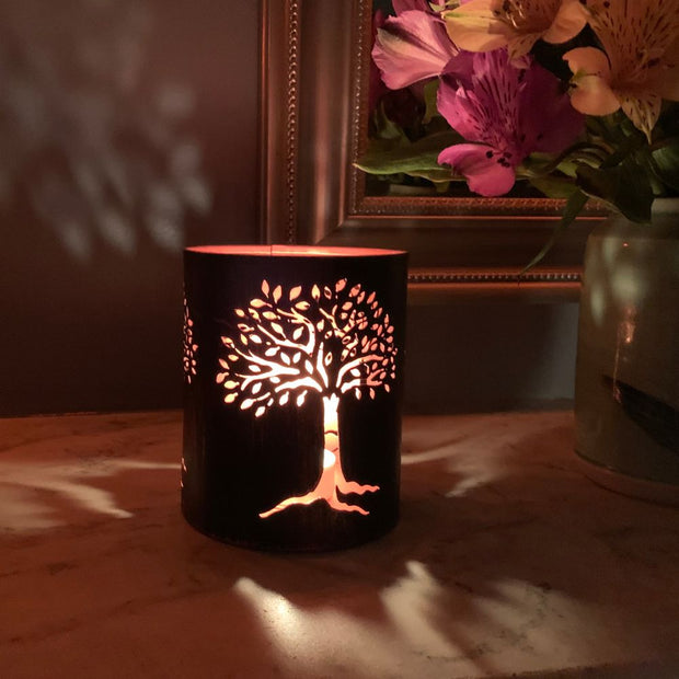 Copper-plated Iron Lantern with Tree of Life cutout shown at night with tea light inside