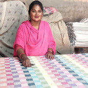 Artisan putting the finishing touches on the Rainbow Gingham Rethread throw