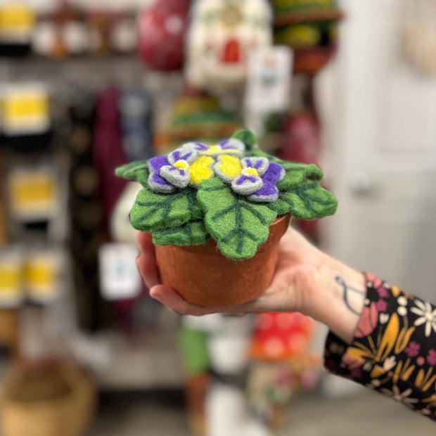 Person holding a Potted Plant Decor that features Felted Pansies in Bloom