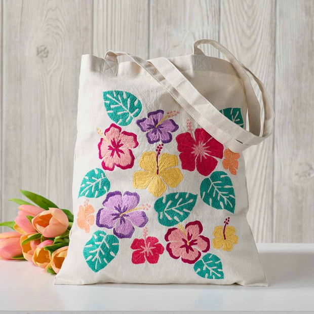 Reusable Tote Bag with Embroidered Tropical Hibiscus design next to tulips