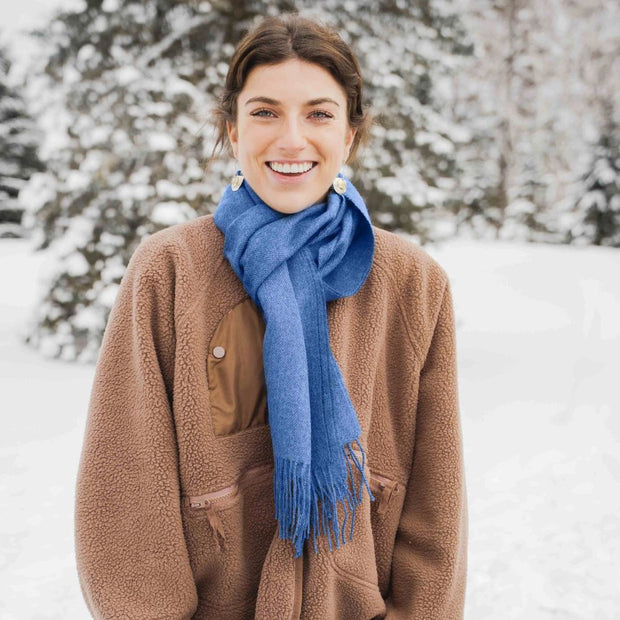 Woman wearing a Solid color 100% Alpaca Fiber Fringed Scarf in blue