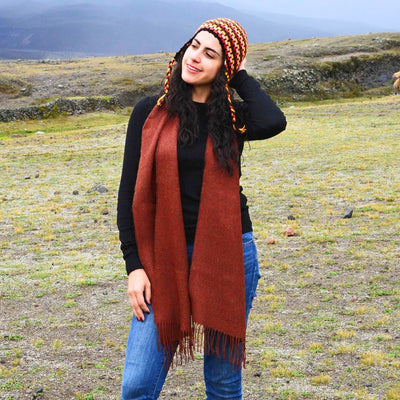 Woman wearing a Solid color 100% Alpaca Fiber Fringed Scarf in Burnt Orange