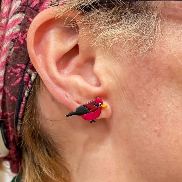 Close-up of an person wearing a Carmesi Cardinal Gourd Stud Earring