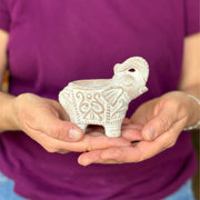 Tiny Terracotta Elephant Tea Light Holder held by a model for size comparison