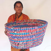 Recycled Sari and Kaisa Grass Laundry Basket held by its maker