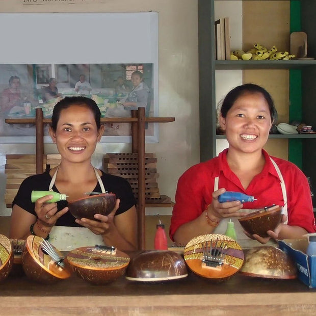 Artisan women from Indonesia working on Summer Groove Coconut Shell Thumb Pianos