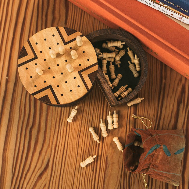 Travel Size Wood Peg Solitaire Game in full action with pegs on board