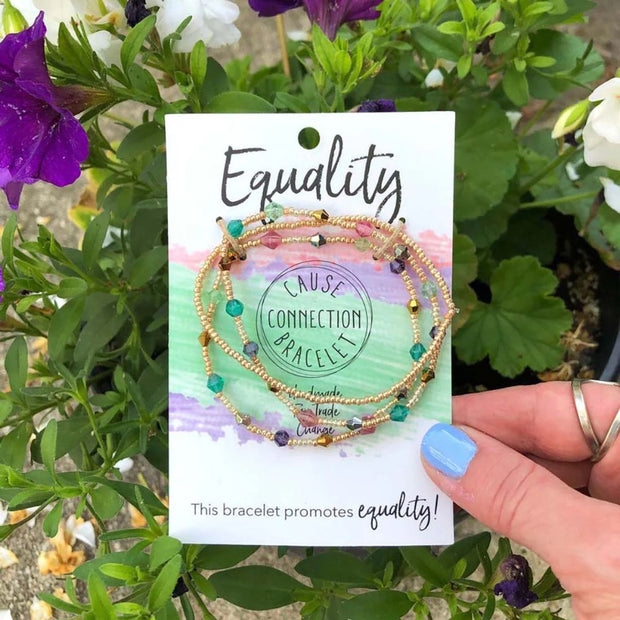Multi Strand Bracelet set on a card with 'Equality' text, held in front of flowers
