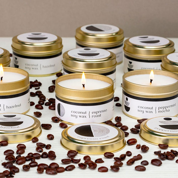 Cafe 4oz Travel Tin Candles styled with coffee beans