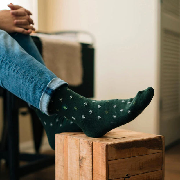 Conscious Step socks that plant trees featuring tiny trees on model