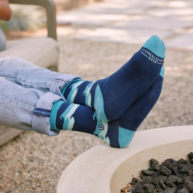 Conscious Step socks that protect oceans featuring rolling waves on model