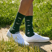 Conscious Step Socks that Protect Elephants in dark green on model