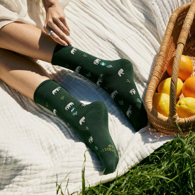Conscious Step Socks that Protect Elephants in dark green on model