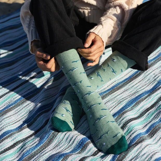 Person wearing Conscious Step Socks that Protect Whales