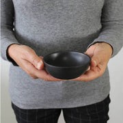 Stoneware Condiment Bowl Dadasi 6 oz Matte Black held by model