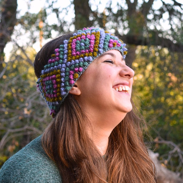 Woman wearing a Diamond Hand-knit Ear Warmer in Floral colors