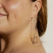 Close-up of a model wearing a Sun-shaped Ethereal Silver Tone Brass Drop Earring