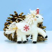 Felt Snowflake Unicorn Ornament styled with pine cones