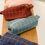 Grid-Stitch Toiletry Pouch Pencil Case Spruce styled with other color options