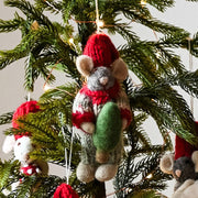 Gry and Sif Handmade Felt Grey Mouse with red hat and knitted sweater Ornament holding a tine Christmas Tree with festive background