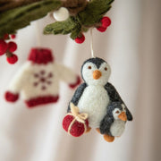 Gry and Sif Handmade felt penguin and baby chick holding a present ornament styled with other ornaments