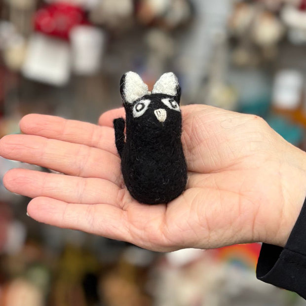 Handmade Felted Wool Tiny Black Cat Ornament held in a hand