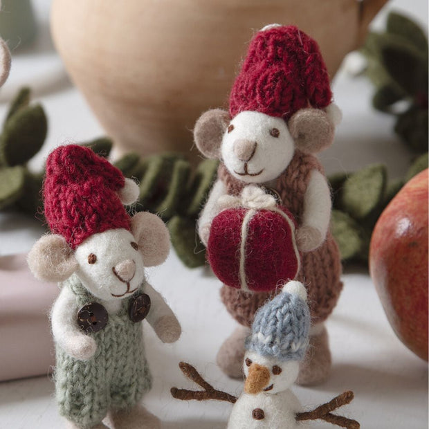 Felt White Mouse Ornament wearing a cozy knit dress and cap holding a Present styled with other ornaments