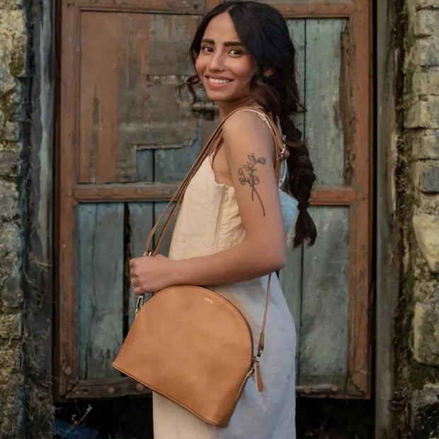 Small Half-Moon Leather Crossbody Bag in camel color - on model