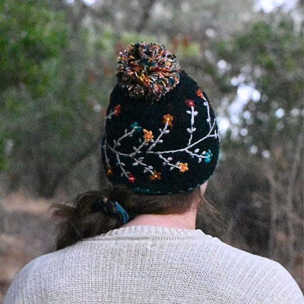 Andes Gifts Hand-knitted Embroidered Flora Winter Hat in Black on model seen from behind