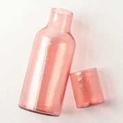 Handblown Hammered Glass Carafe - Blush on its side without the lid