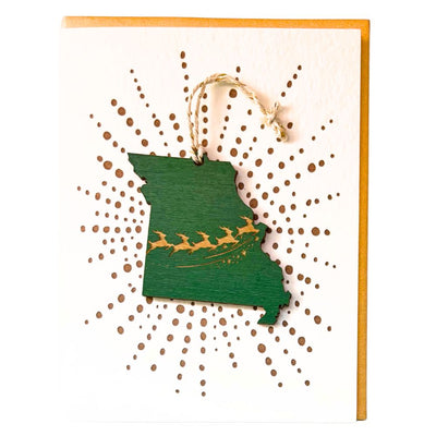 Holly Green wooden cutout of a Missouri with flying reindeer design ornament attached to a greeting card