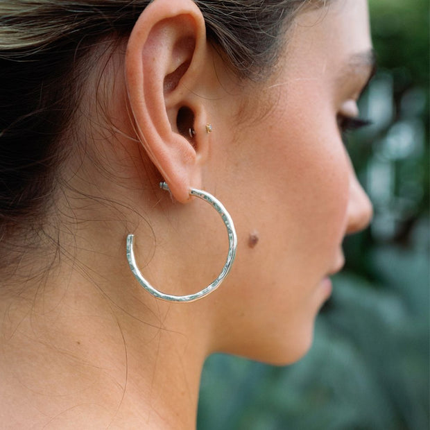 Model wearing Bhavani Hammered Silver Open Hoop Earrings