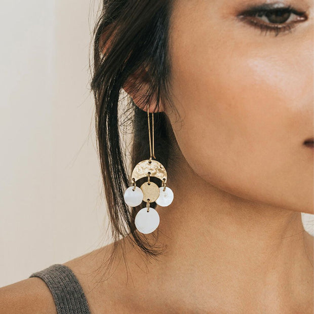 Close-up of a woman wearing Lunar inspired Rajani Mother of Pearl Chandelier Earrings
